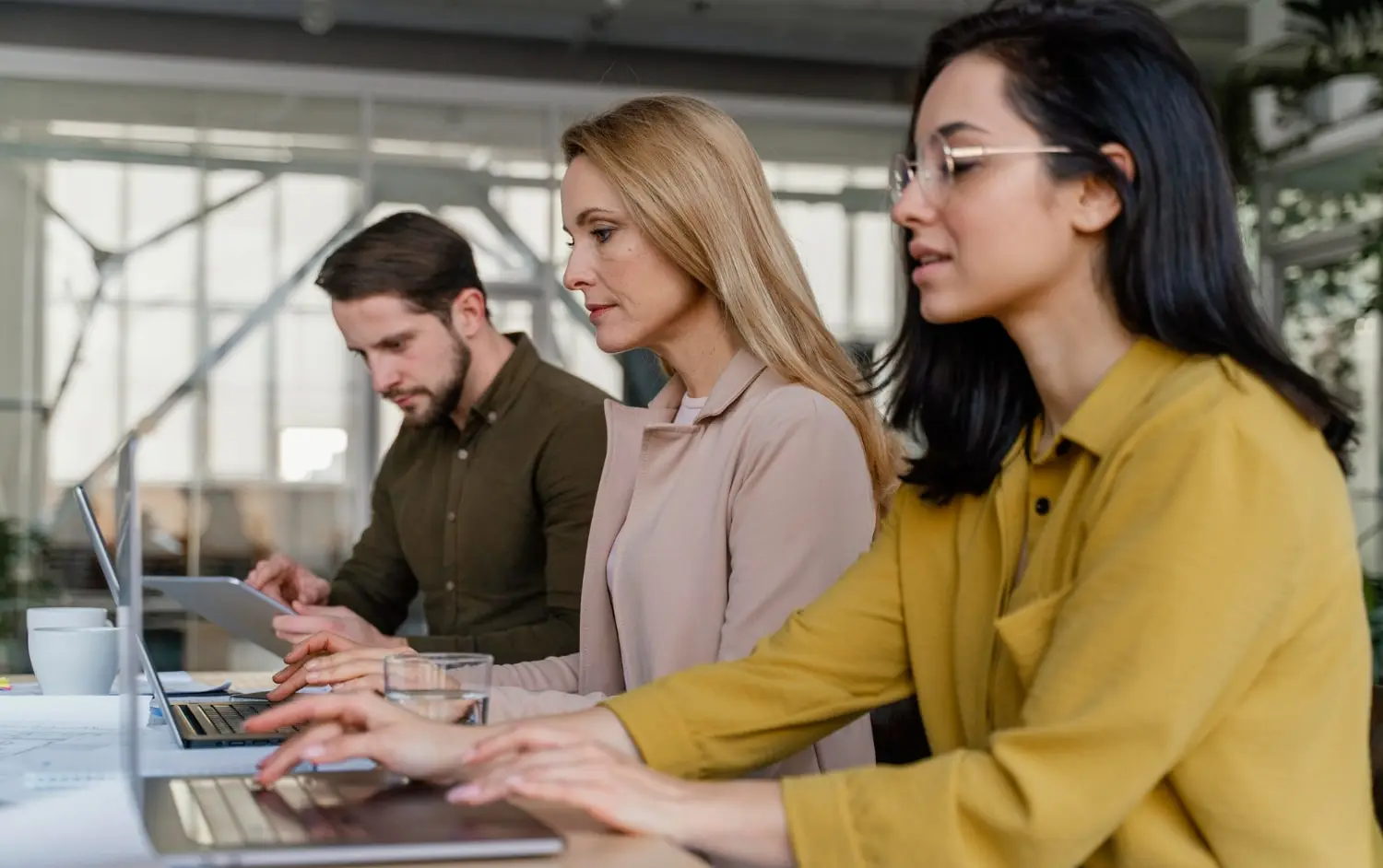 A team of people working on laptops 